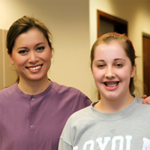 Pediatric Dentist Grosse Pointe Woods MI Dawn Yuen Harvey With Smiling Patient HP Pediatric Dentist Dawn Yuen Harvey With Smiling Patient In Sweatshirt