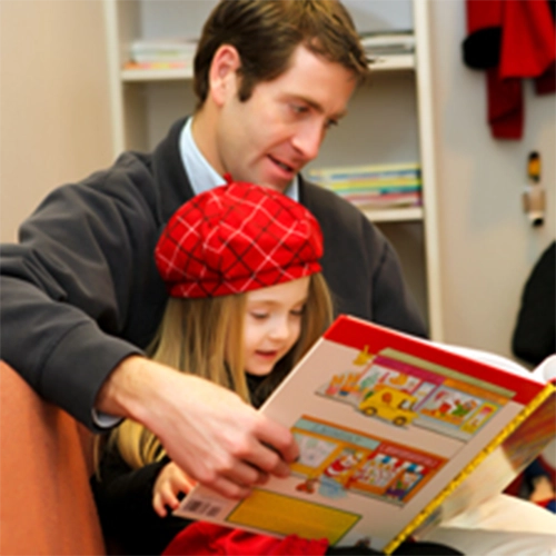 Pediatric Dentist Grosse Pointe Woods MI Man Reading With Child HP Man Reading With Child In Red Plaid Beret