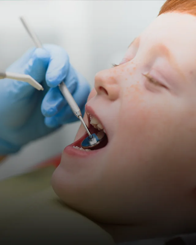 A child with his mouth open during a dental exam