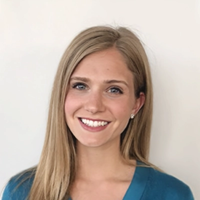 Pediatric Dentist Rachel Zurek Smiling In Blue Shirt